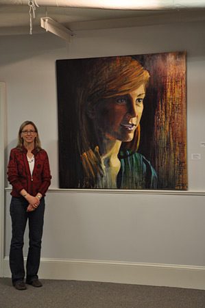 Leigh displays paintings at an Art Exhibit at Winthrop University.